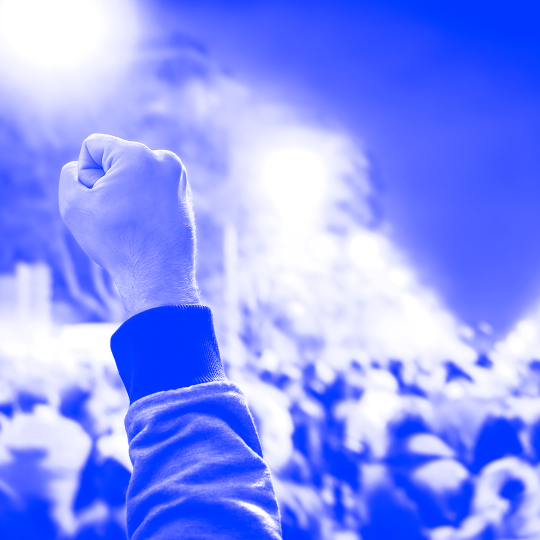 Group of people fighting together lifting a closed fist